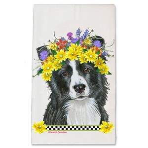 May include: A black and white border collie dog wearing a flower crown with yellow, red, purple, and blue flowers. The dog is looking at the camera.