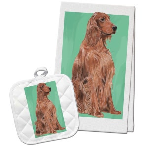 May include: A set of kitchen towels and pot holders featuring a red Irish Setter dog sitting on a green background. The dog is looking to the right. The towels are white with a green border.