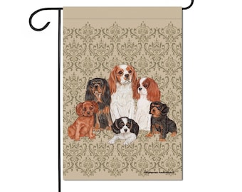 May include: A garden flag with a beige background and a damask pattern. Six Cavalier King Charles Spaniels are featured in the center of the flag. The dogs are in various poses and colors, including black, white, brown, and red.