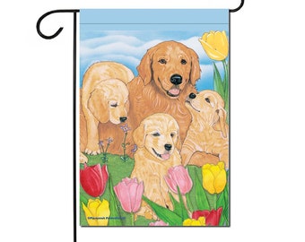 May include: A garden flag with a blue background and a family of golden retriever dogs surrounded by colorful tulips. The dogs are all looking at the viewer. The flag is perfect for dog lovers and spring.