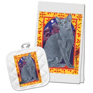 May include: A set of kitchen towels featuring a blue Russian Blue cat sitting in a yellow and red frame with a cityscape in the background. The set includes a tea towel and a pot holder.