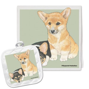 May include: A set of two white kitchen towels with a green background featuring a watercolor illustration of two Pembroke Welsh Corgi puppies. The towel on the left is a pot holder with a quilted design. The text "©Pipsqueak Productions" is printed in black at the bottom right corner of the larger towel.
