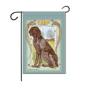 May include: A brown and white German Shorthaired Pointer dog sits in a field with a blue sky and trees in the background. The dog is framed by a decorative border with two pheasants on branches.