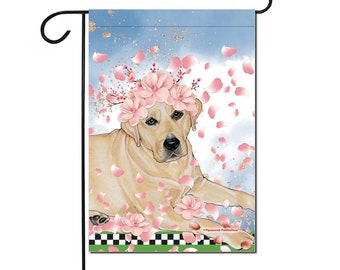 May include: A yellow Labrador Retriever wearing a pink flower crown, surrounded by pink flower petals against a blue sky background.