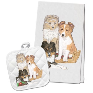 May include: A set of four white kitchen towels with a colorful illustration of four Shetland Sheepdog puppies. The puppies are sitting in a wicker basket. The towels are perfect for adding a touch of whimsy to your kitchen.