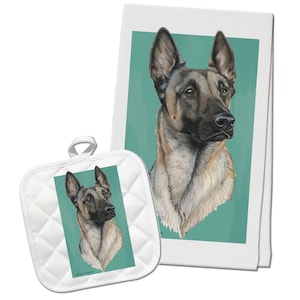 May include: A white kitchen towel and matching pot holder feature a painting of a Belgian Malinois dog with a light brown and black coat. The dog is looking to the right of the image. The background is a teal green color.