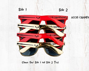 May include: Red and gold sunglasses with the text "Accio Champagne" on one side and a wand and stars on the other side.