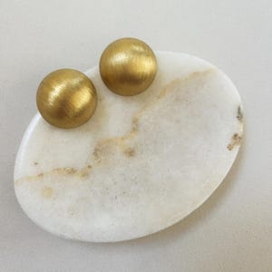 vintage earrings on a stone piedestal