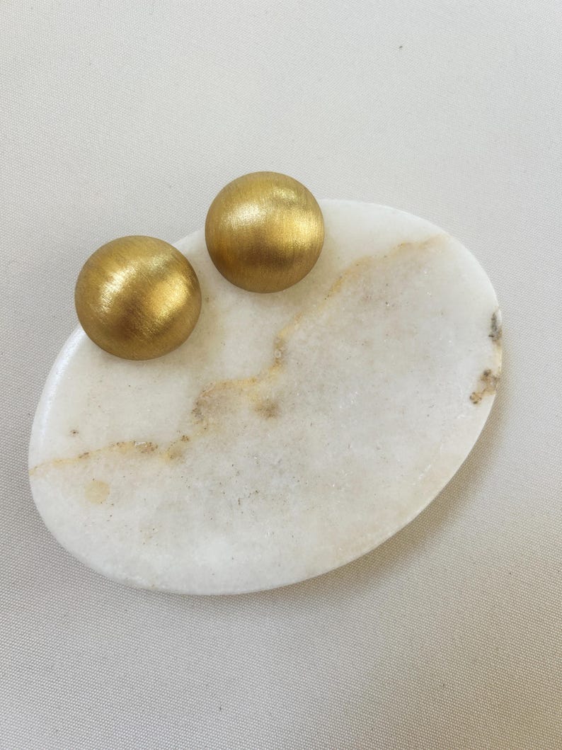 vintage earrings on a stone piedestal