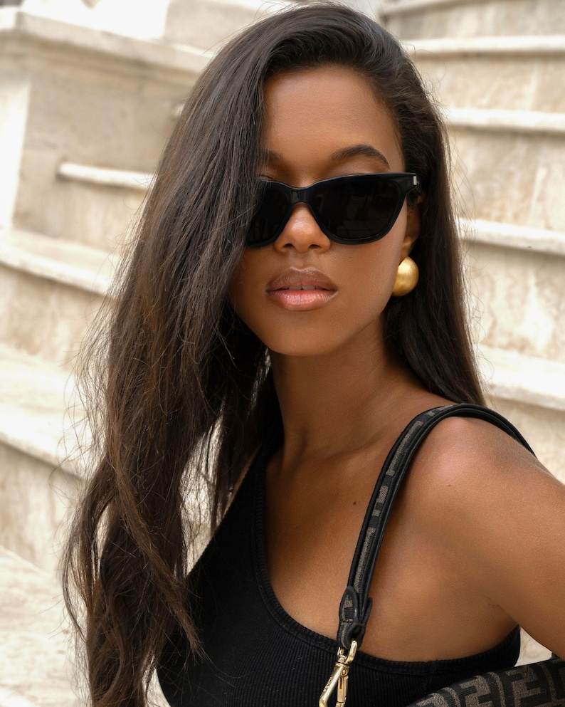 large gold dome earrings styled with sunglasses