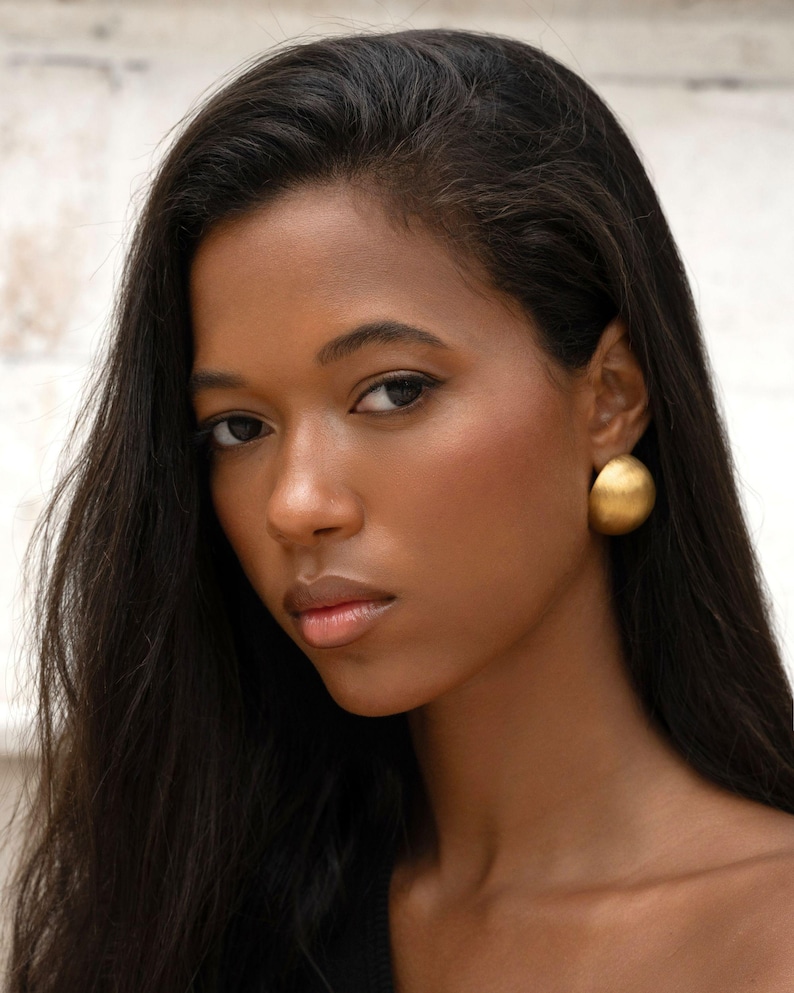 statement earrings on a dark skinned women