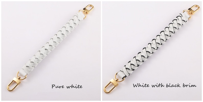 May include: Two white braided leather straps with gold metal clasps. The strap on the left is pure white, while the strap on the right has a black trim.