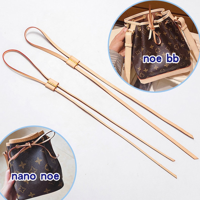May include: Two beige leather straps with yellow stitching. The straps are long enough to be used as shoulder straps for a small handbag. The text "noe bb" and "nano noe" are visible in the image.