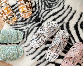 May include: A set of six colorful patterned slippers. The slippers are made of a soft, comfortable material and have a variety of designs, including plaid, geometric, and floral patterns.