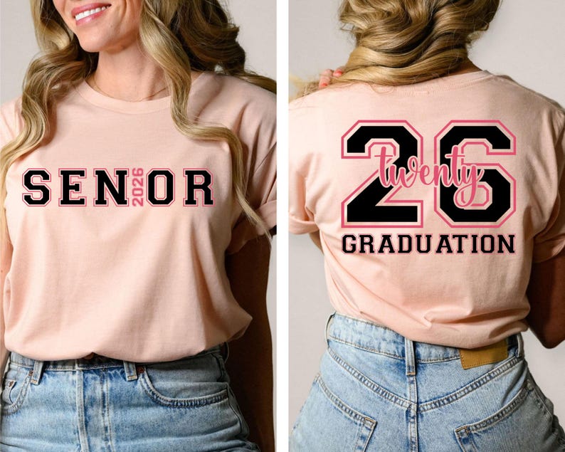 May include: A light pink t-shirt with the word "SENIOR 2026" printed on the front in black and pink lettering. The back of the shirt features the number "26" with the word "Twenty" inside and the word "GRADUATION" below.