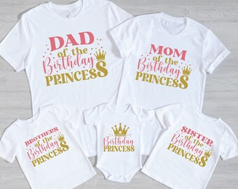 May include: Set of five white t-shirts with pink and gold text and crown graphics. The shirts say "Dad of the Birthday Princess", "Mom of the Birthday Princess", "Brothers of the Birthday Princess", "Birthday Princess", and "Sister of the Birthday Princess".
