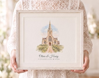 Puede incluir: Una impresión cuadrada enmarcada con una ilustración en acuarela de una iglesia de piedra con una torre alta, rodeada de vegetación. Debajo de la iglesia, el texto dice Olivia & Henry, ST. CATHERINE'S CHURCH, un corazón y 02.02.2026.