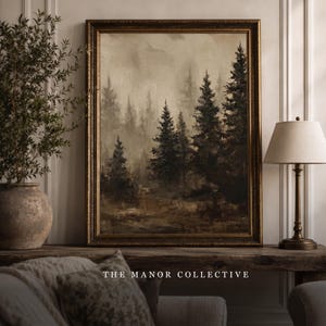 May include: A framed landscape painting depicting a dark, misty forest with tall evergreen trees in shades of brown, black, and muted gray. The artwork is enclosed in an ornate, dark gold frame and features the text THE MANOR COLLECTIVE at the bottom.