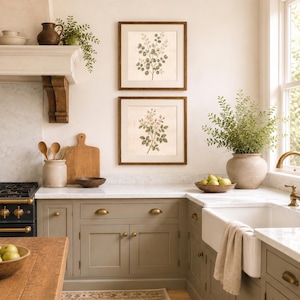 Set of two botanical prints displayed above a bed in a cottagecore bedroom with vintage French country decor.