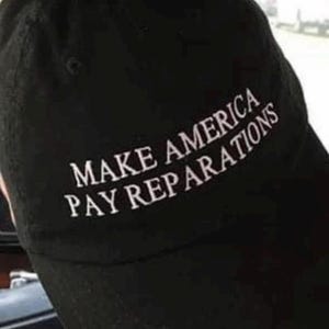 May include: A black baseball cap with white embroidered text that reads "Make America Pay Reparations".