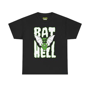May include: Black t-shirt with a green and white graphic. The graphic features a bat with the words "BAT OUT OF HELL" in a bold, stylized font. The shirt also has the text "BEYOND PERIL" at the top.