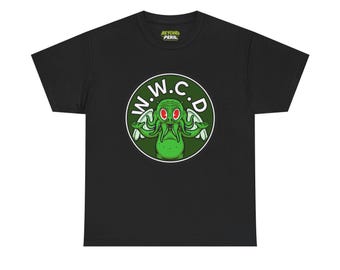 May include: A black short-sleeve t-shirt featuring a circular graphic on the chest. The graphic shows a green tentacled creature with red eyes and wings, surrounded by the white text W.W.C.D. The inner neck label displays the text BEYOND PERIL.