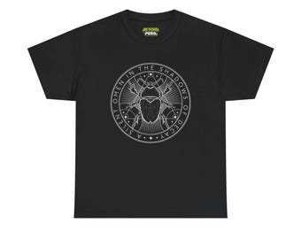 May include: A black short-sleeve t-shirt featuring a white circular graphic on the chest. The design depicts a beetle surrounded by geometric lines, stars, and the text A SILENT OMEN IN THE SHADOWS OF DECAY. A Beyond Peril brand label is at the neck.