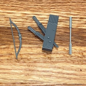 May include: A gray plastic quiver with three gray plastic swords and a gray plastic bow and arrow.