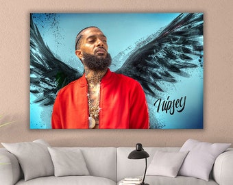 May include: A digital painting of a man with a red jacket and a black beard. He is wearing a gold chain and has angel wings behind him. The text "Nipsey" is written in the bottom right corner of the image.