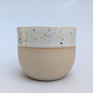 White speckled ceramic coffee cup, handle less mug 7oz
