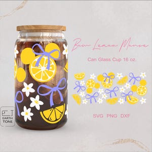 May include: A glass jar with a yellow and purple lemon design. The jar is filled with a dark liquid and has a wooden lid. The text "Bam Lemon Mouse" and "Can Glass Cup 16 oz." is visible. The text "SVG PNG DXF" is also visible.