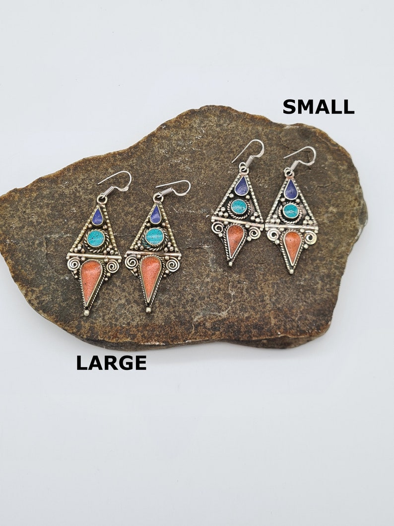 May include: Two pairs of earrings, one pair is labeled "SMALL" and the other pair is labeled "LARGE". Both pairs are silver with turquoise and blue stones and coral accents.