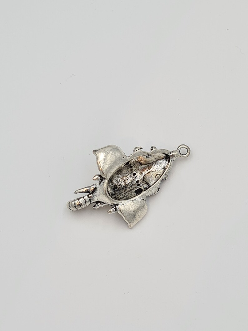 Op de afbeelding: Zilveren bedel in de vorm van een olifant met een gedetailleerd ontwerp. De bedel heeft een lus aan de bovenkant om aan een armband of ketting te bevestigen.