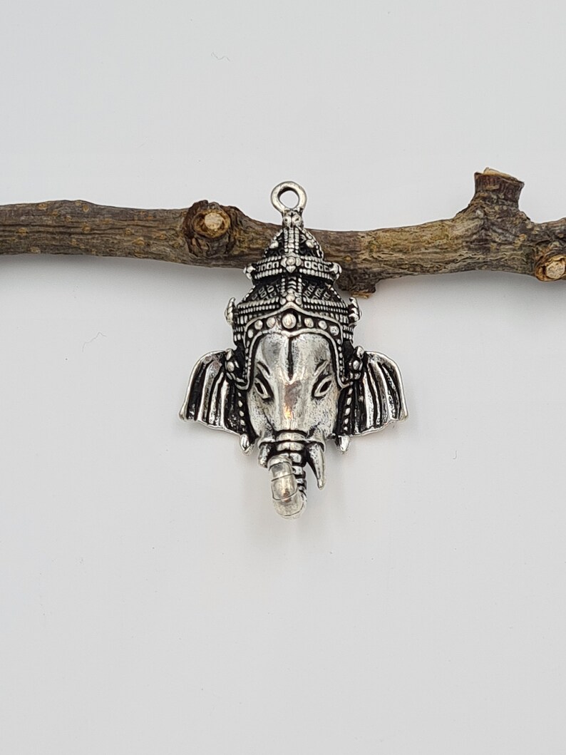Op de afbeelding: Zilveren hangerbedel met een gedetailleerde afbeelding van de hindoe-godheid Ganesha, de olifantenkopgod van wijsheid en geluk.