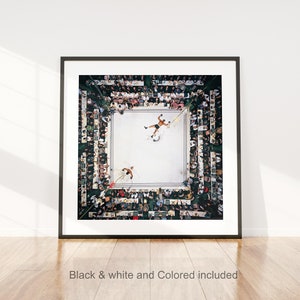 May include: Framed print of a boxing match viewed from above. Two boxers are in the ring, surrounded by a crowd of spectators. The image is in a black frame and includes the text "Black & white and Colored included".