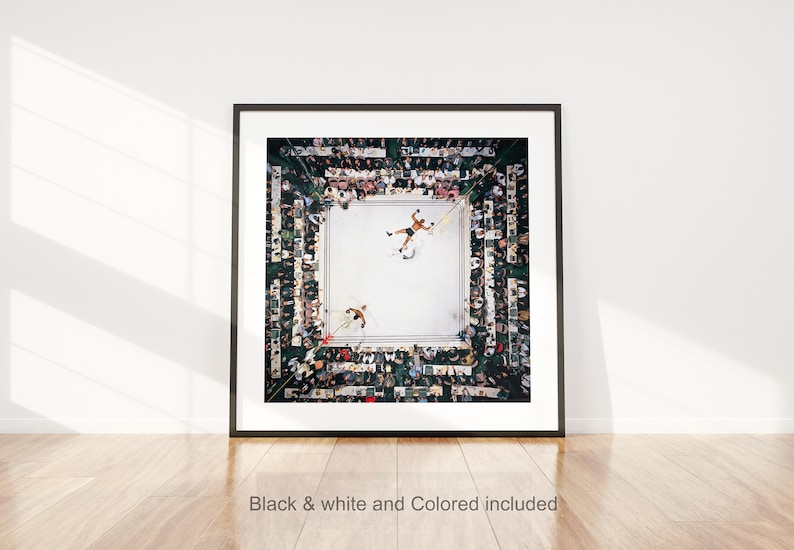 May include: Framed print of a boxing match viewed from above. Two boxers are in the ring, surrounded by a crowd of spectators. The image is in a black frame and includes the text "Black & white and Colored included".