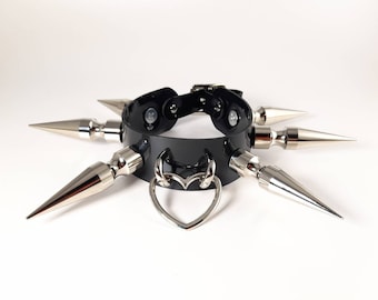 May include: Black leather choker with silver spikes and a heart-shaped charm.