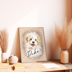 May include: A framed portrait of a happy, light-colored dog named Duke. The artwork features a watercolor-style background with the dog's name in cursive and a small heart. The frame is a light gold color, and the portrait is leaning against a wall.