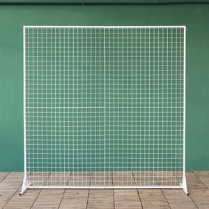 May include: White metal grid backdrop with a square grid pattern. The backdrop is freestanding and has a white metal base.