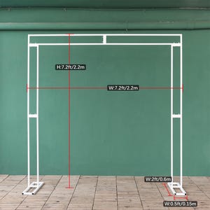 May include: White metal archway backdrop stand with measurements in feet and meters. The stand is 7.2 feet wide and 7.2 feet tall, or 2.2 meters wide and 2.2 meters tall. The base of the stand is 2 feet wide or 0.6 meters wide. The stand is 0.5 feet wide or 0.15 meters wide.