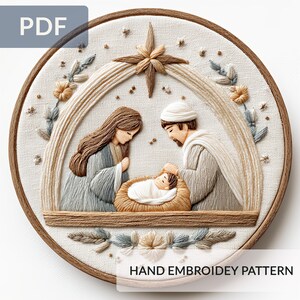 May include: A hand-embroidered nativity scene in a round wooden frame. The artwork features Mary, Joseph, and baby Jesus, with a star above. The design includes beige, brown, and blue thread, with the text "HAND EMBROIDERY PATTERN".
