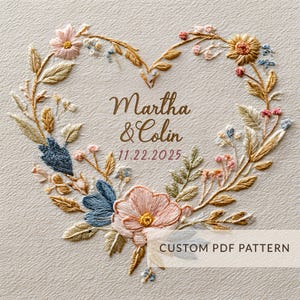 May include: Embroidered heart-shaped floral design with the names "Martha & Colin" and the date "11.22.2025" in gold lettering. The design features various flowers in shades of pink, blue, and yellow, with green and gold leaves. The text "CUSTOM PDF PATTERN" is at the bottom.