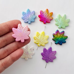 May include: Assortment of iridescent resin maple leaf charms in various colors, including pink, blue, yellow, green, purple, and orange. The charms are perfect for jewelry making, scrapbooking, and other craft projects.