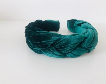 May include: A dark green velvet headband with a braided design. The headband is thick and wide, and it is perfect for adding a touch of elegance to any outfit.