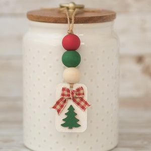 May include: A set of three ceramic mugs with a speckled, cream-colored glaze. Each mug features a different hand-painted floral design in shades of blue, green, and yellow. The mugs have a simple, rounded shape and a comfortable handle.