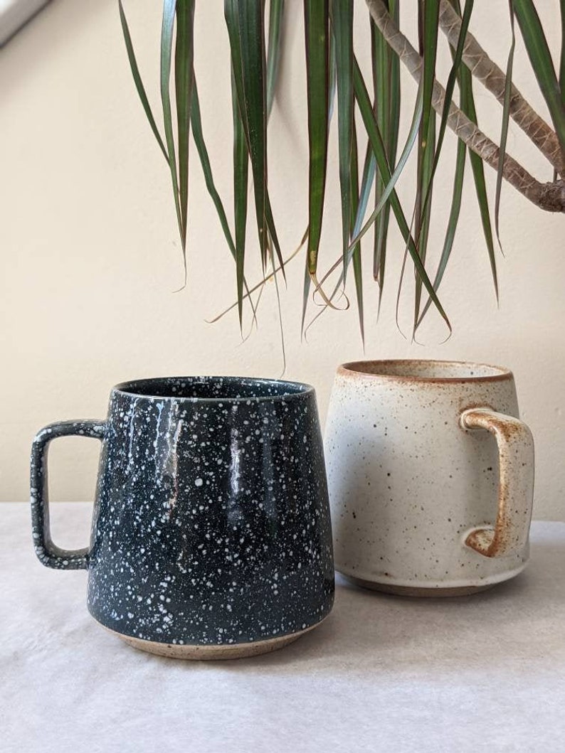 two nordic styled speckled coffee mugs