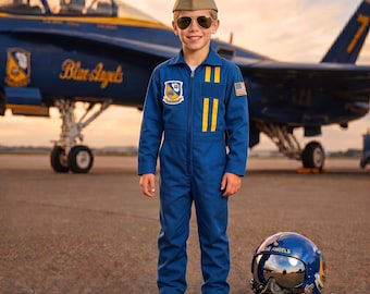 May include: A blue flight suit with yellow vertical stripes on the chest, a Blue Angels patch, and a United States flag patch on the sleeve. The outfit includes a tan garrison cap, dark aviator sunglasses, and black boots, with a blue flight helmet.
