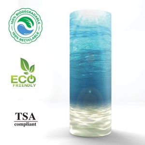 May include: A blue and white tumbler with an ocean scene. The tumbler is made from 100% biodegradable and recyclable materials. It is also TSA compliant and eco-friendly.