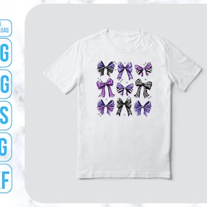 May include: A white t-shirt with a design of purple and black bows with white polka dots. The bows are arranged in a grid pattern on the front of the shirt.