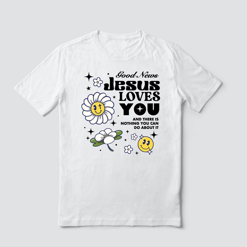 May include: White t-shirt with a graphic design featuring a daisy, a smiley face, and the text "Good News Jesus Loves You" and "And there is nothing you can do about it".